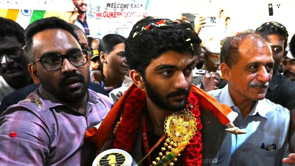 Gukesh D being garlanded after becoming the youngest grand master